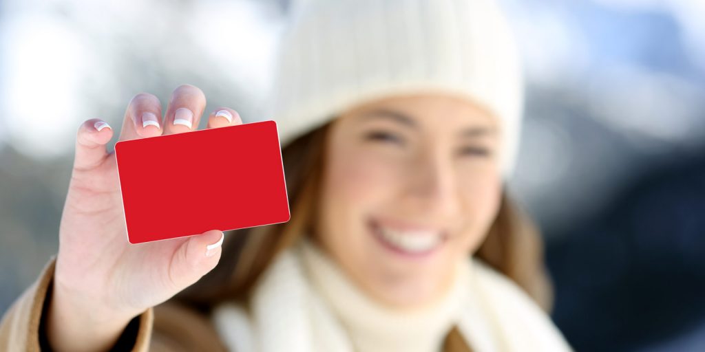 woman smiling holding gift card