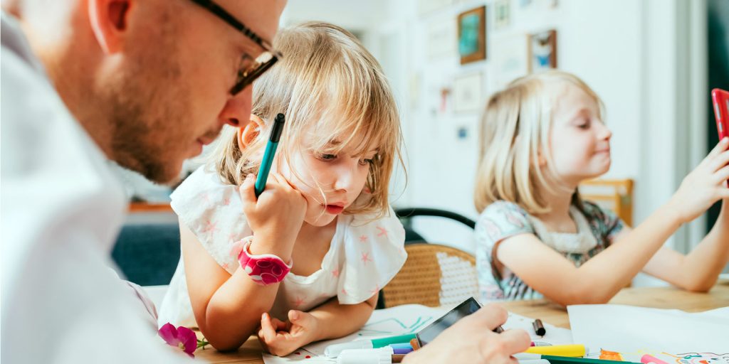Father doing school work with children at home