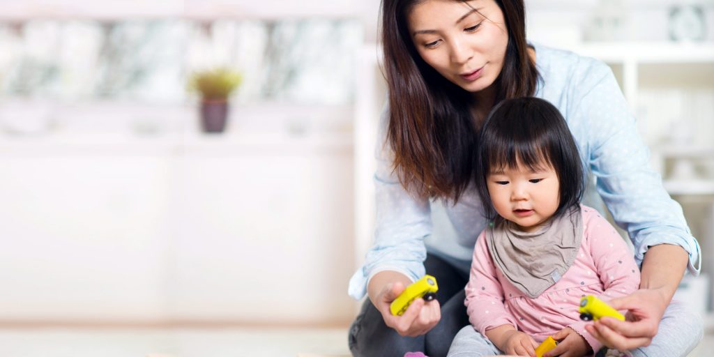 young Mother of Asian decent playing with small child