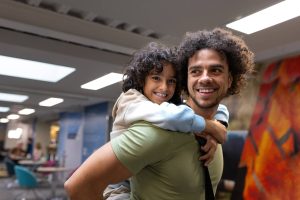 son on father's back