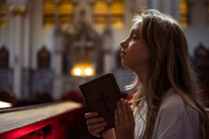 girl praying at church