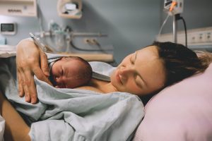 woman lying with baby