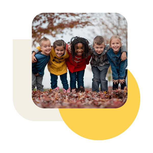 group of kids posing for the camera outside